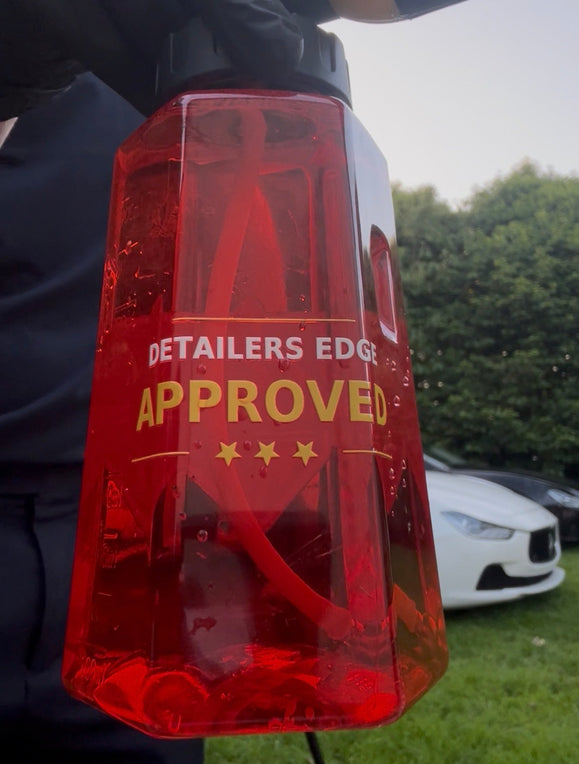 Measured car-detailing liquids being diluted with water in labelled bottles before vehicle cleaning.