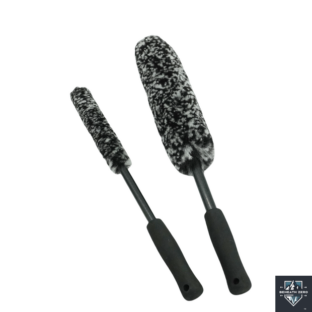 Two car cleaning brushes with black handles and gray bristles on a white background.