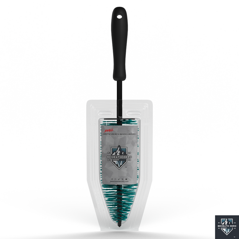 Cleaning brush with black handle and green bristles in a clear packaging on a white background